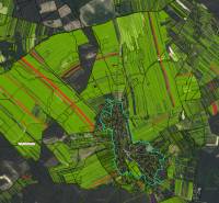 Aerial view of agricultural and forest land around Studienka, with prominent green parcels.