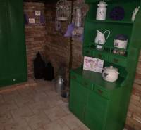 A family house with a brick wall, green furniture, and decorations with a lavender motif.