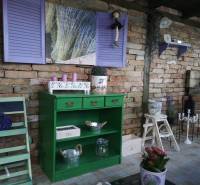 Interior with a green dresser, lavender, and a brick wall in a family house.
