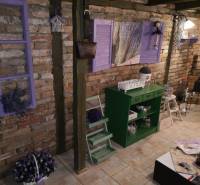 Brick wall and lavender decorations in the interior of a family house with flooring.