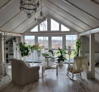 Attic room of a family house with a rocking chair and a wooden decor floor.
