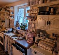 Vintage kitchen in a family house with decorations and ceramic dishes, floor with wooden decor.