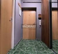 Interior of a 2-room apartment with green tile flooring and a mirrored wardrobe.