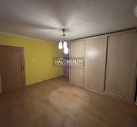 A room in a 2-room apartment with a floor featuring a wooden decor and a built-in wardrobe.