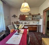 A kitchen with a family table and vintage furniture in a family house.