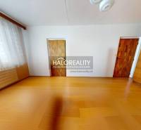 A room in a 3-room apartment with a wood-patterned floor, a large window, and a built-in wardrobe.