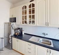 A kitchen in a 3-room apartment with light cabinets and built-in appliances.