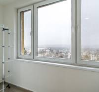 A balcony with a view in a 2-room apartment, a clothes rack, a city in fog.