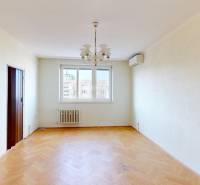 Living room in a 3-room apartment with a chandelier and wooden decor flooring.