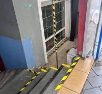 Stairs with safety features lead to the entrance of commercial premises on Račianska Street.