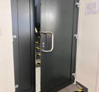 Opening metal doors in commercial premises, behind which are stairs.