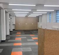 Commercial spaces with divided rooms, gray-orange flooring, and glass walls on Račianska.