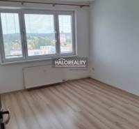 A bright room in a 3-room apartment with a wooden decor floor and a large window.