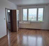 A room with a wooden decor floor and large windows in a 3-room apartment.