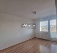 A room with a wooden floor design and a large window in a 3-room apartment.