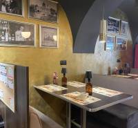 Interior of gastro spaces with wooden decor and historical photographs on the walls.