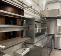 A kitchen in a gastro space with stainless steel equipment and a sink.