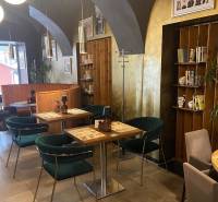 Gastro premises with vaulted ceilings, wooden decor, and comfortable seating.