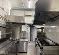 Professional kitchen with metal equipment and wood-decor flooring in gastro premises.
