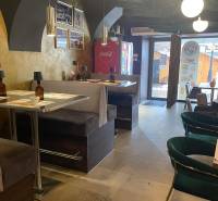 Interior of a gastro space with comfortable seating and decorative lighting.