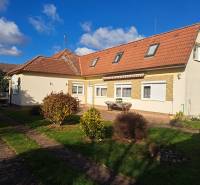 A family house on Bernolákova Street in Vráble, surrounded by a green garden and a blue sky.