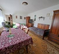 Living room in a family house with furniture, dining table, and decorations.