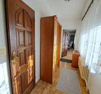 Interior of a family house with tiles, wooden doors, and a glass wall.