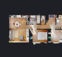 Floor plan of a 4-room apartment with wood-patterned flooring and furnishings.