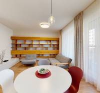 Living room with wood-patterned flooring, a sofa, and an original wall shelf.