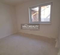 Empty room with white walls and a large window in a family house.