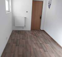 White wall, brown door, wooden decor flooring in a family house.