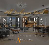 Living room with a sofa and dining table in a family house with a wooden decor floor.