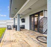 A terrace next to a family house on Mostová Street in Galanta with seating and a swing.