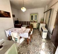 Traditional kitchen in a family house with vintage furniture and a decorated floor with a pattern.