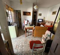 Interior of a family house with retro decor and decorative flooring. Rustic furniture and a stove.