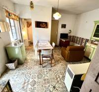 Interior of a family house, retro furniture, tiled floor, dining and living area.