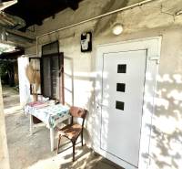 A family house in Jablonec with a table and a chair in the yard.