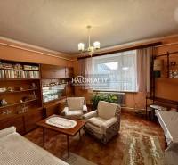 Living room of a family house with wooden decor furniture and curtains.