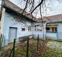 A family house in Prievidza with a blue facade and fencing on a smaller plot.