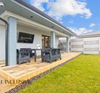 The terrace of a family house on Mostová Street in Galanta with seating and a lawn.