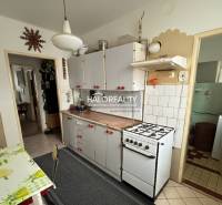 Kitchen in a 3-room apartment with a gas stove and a dining area.