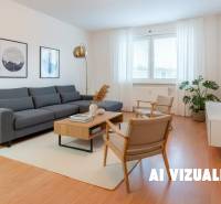 Living room with a gray sofa, armchairs, and a wooden decor floor in a 4-room apartment.