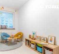 Children's room in a 4-room apartment with toys, wooden decor flooring, and colorful chairs.