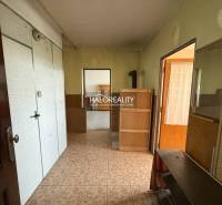 A hallway in a 3-room apartment with wooden and white elements on the walls.