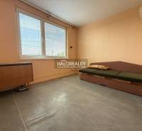 A bright room with a sofa in a three-room apartment, wooden furniture, large window.