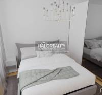 A bedroom in a 3-room apartment with an elegant bed, white furniture, and a light fixture.