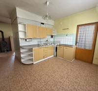 A kitchen with tiles and a wooden cabinet in a 3-room apartment.