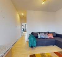Living room with a corner sofa, wooden decor flooring, 3-room apartment.