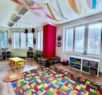 Offices with bright space, wooden decor flooring, children's play rugs, colorful decorations.