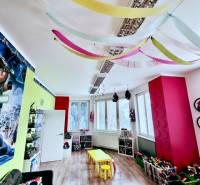 Colorful children's playroom with a wooden decor floor and vibrant decorations in the offices.